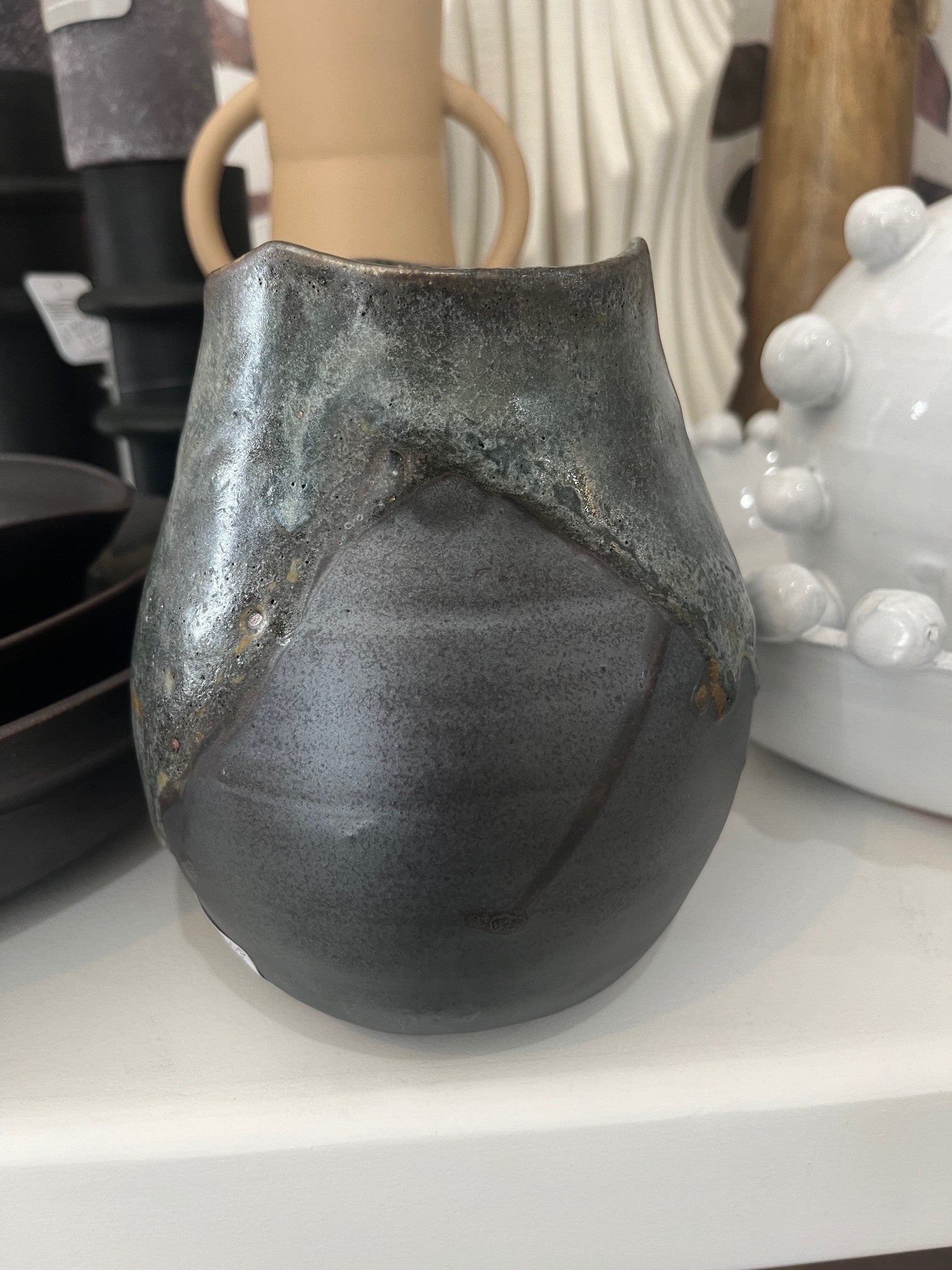 Round black and mottled blue vase with triangular base